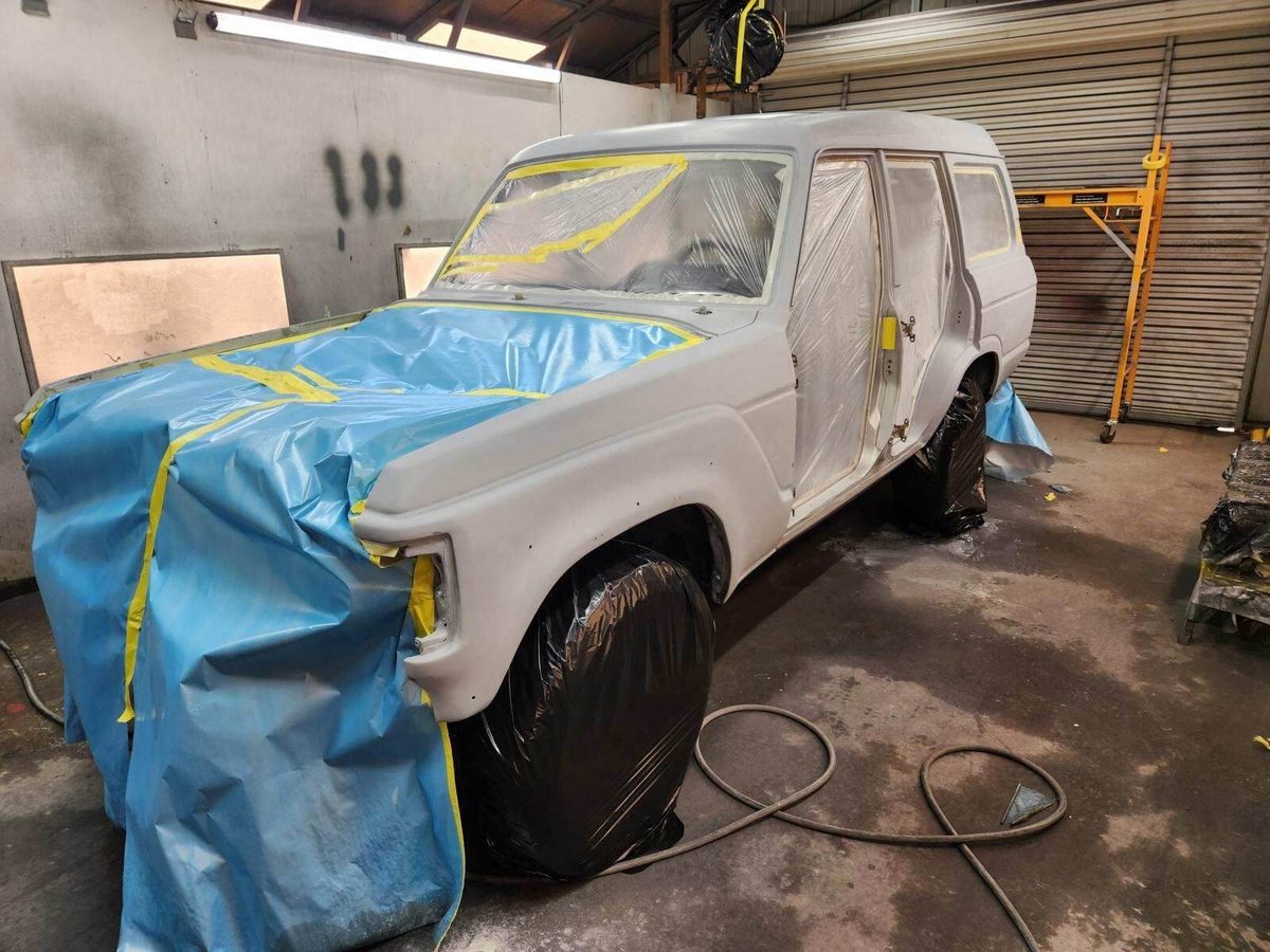 FJ62 masked and in paint booth